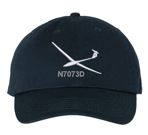 Image shows a baseball cap with an embroidered glider aircraft design and custom tail number.