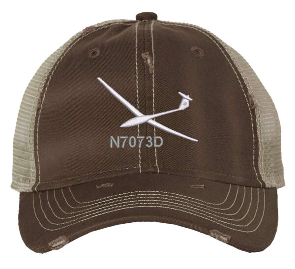 Image shows a trucker hat with an embroidered glider aircraft design and custom tail number.