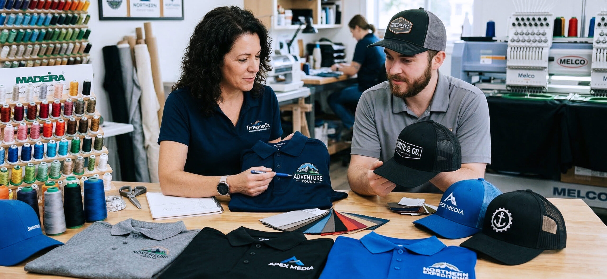 business team reviewing branded uniforms with embroidered logos