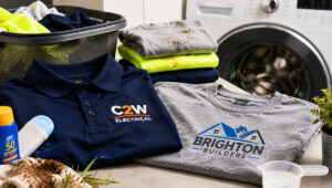 Embroidered polo and printed work shirt being prepared for proper summer uniform washing